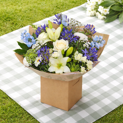 Oceanic Bliss - Revel in the elegance of this luxurious bouquet, featuring a captivating mix of white and blue blooms. Presented in beautiful packaging, it’s perfect for making a sophisticated statement.