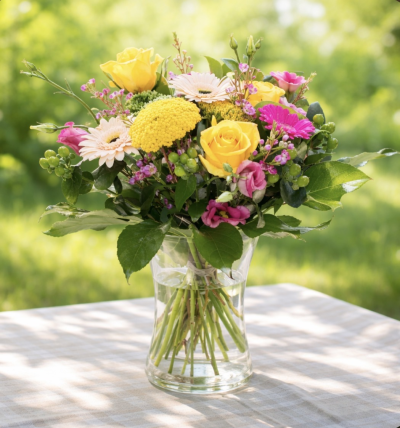 The Happy Vase - Happy Vase floral arrangement, made up of bright blooms and leaves.