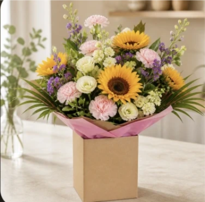 Bright Ideas - Beautiful Sunflowers and a peppering of other summer flowers and foliage. Tied in water and presented in a stylish bag. An amazing bouquet full of joy and delight ready to display and enjoy.